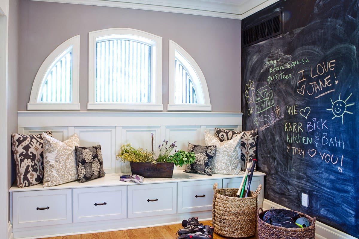 Large mud and laundry room with built-in storage and a chalkboard wall