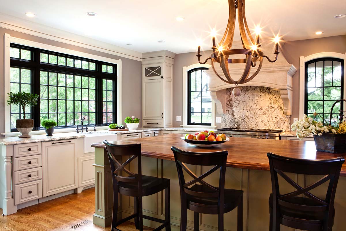 a spacious kitchen remodel with a large island and granite countertops and backsplash