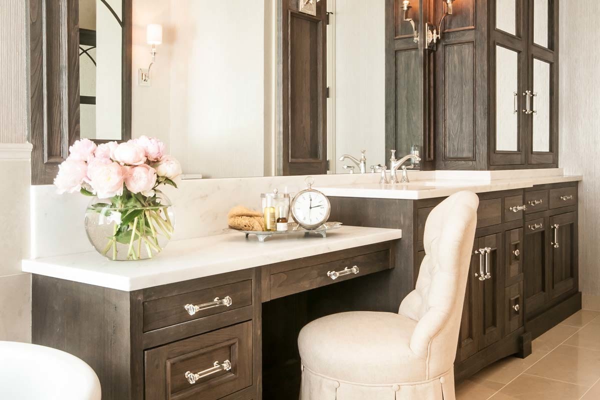 an upscale bathroom vanity upgrade with white countertops and wooden cabinetry
