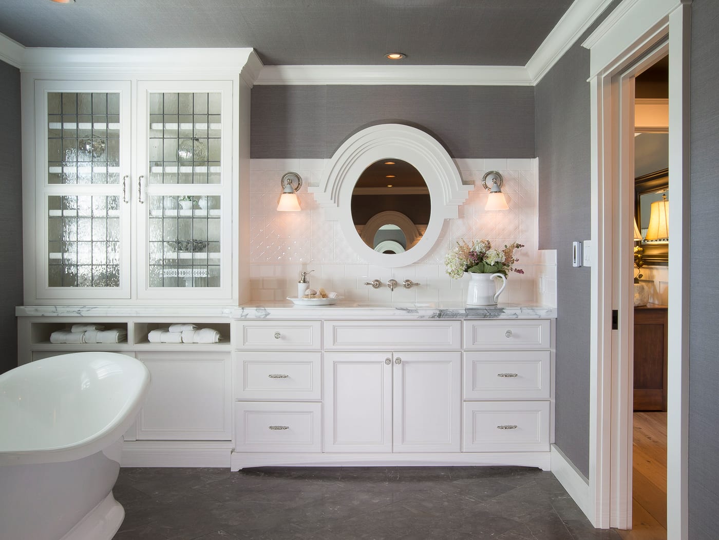 white master bath with grey floors and pedestal floor