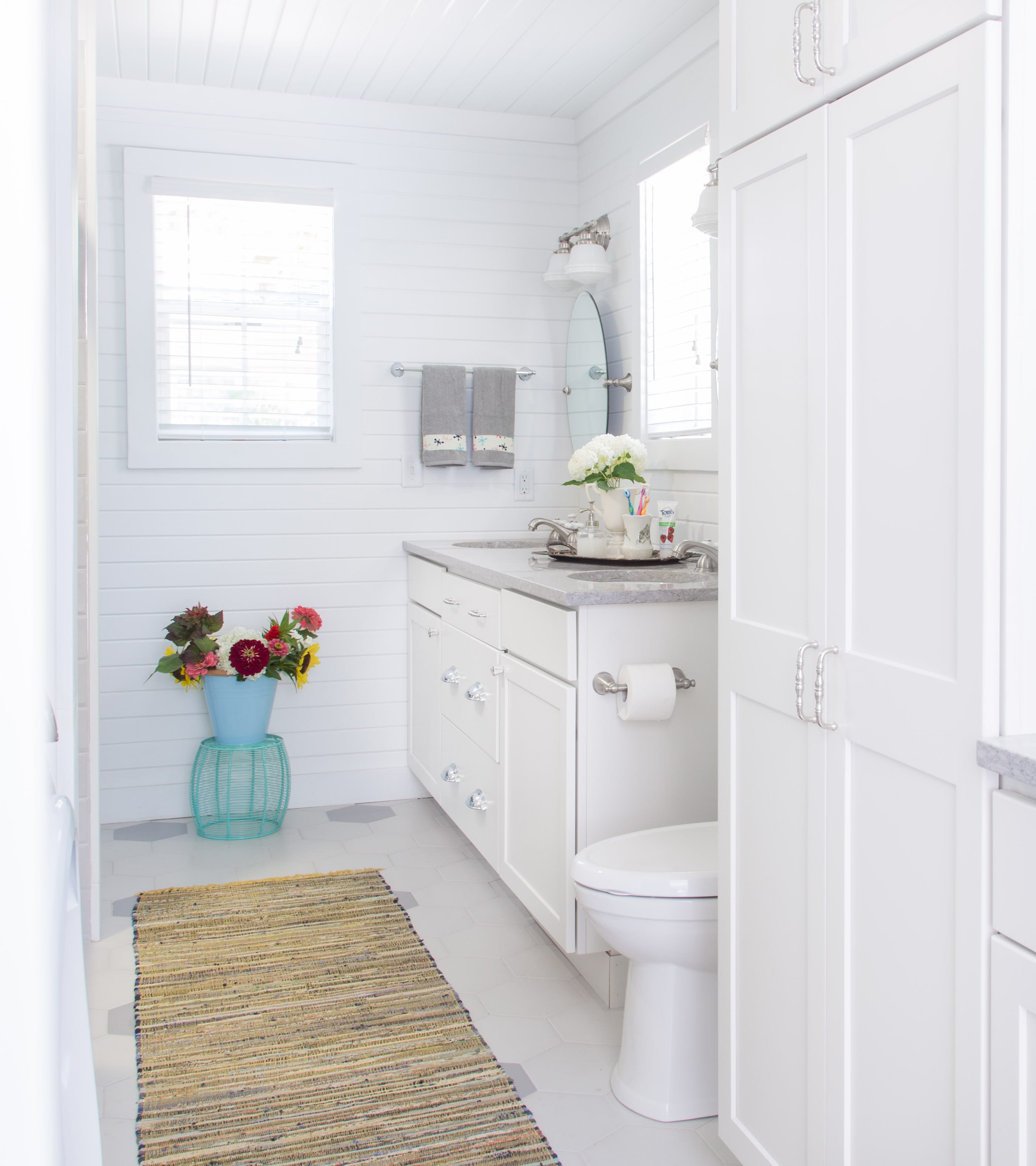 white bathroom remodel with gray tops