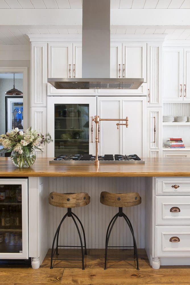 white kitchen remodel with wood tops and pot filler