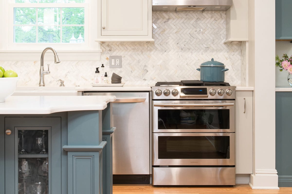 close up of a blue and white kitchen remodel with silver fixtures