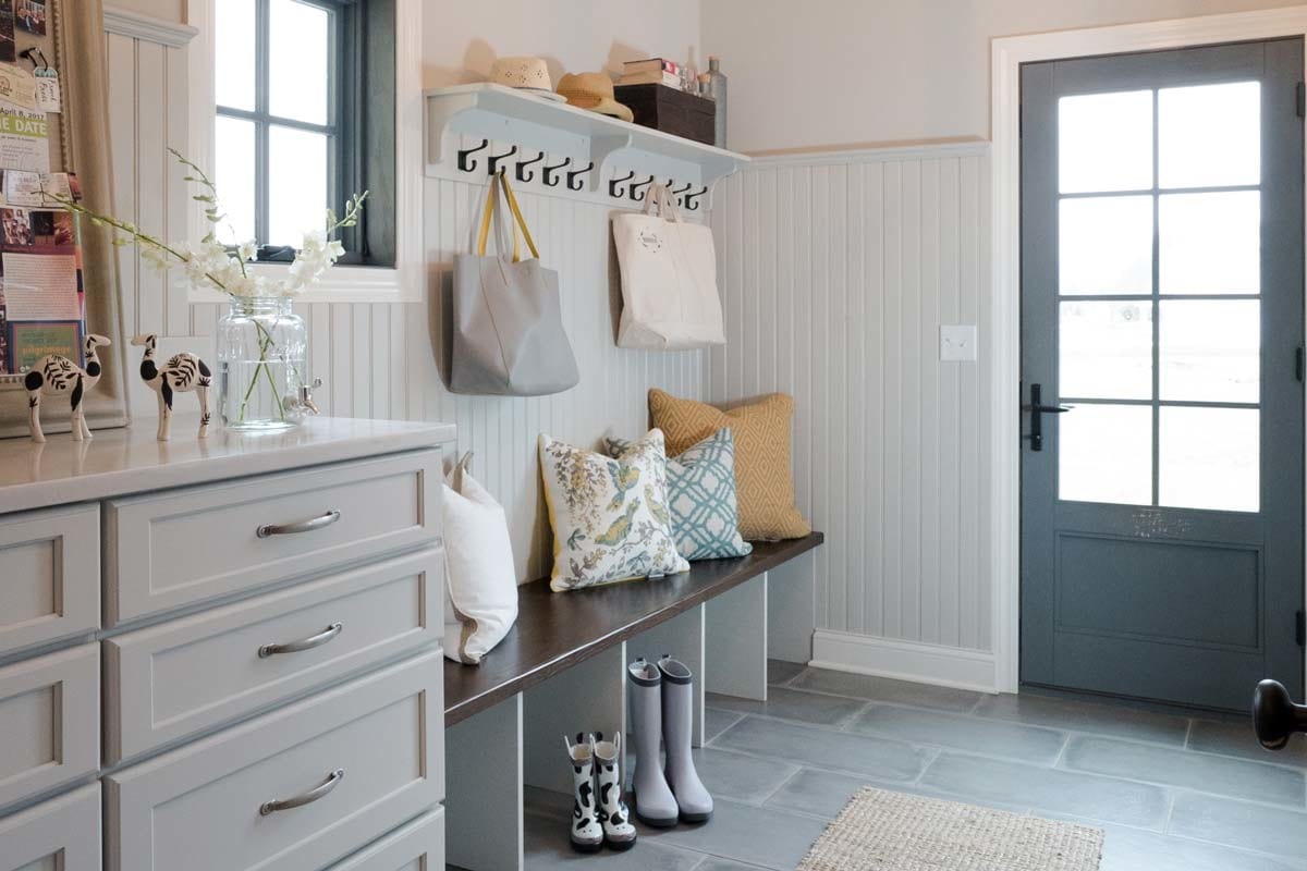 a bright functional mud and laundry room with natural light streaming in