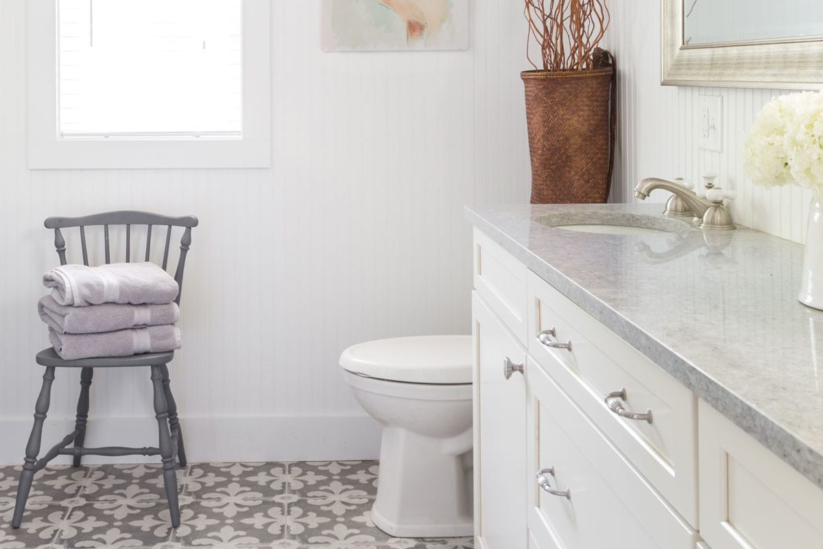 a cottage styled bathroom remodel with white and grey accents