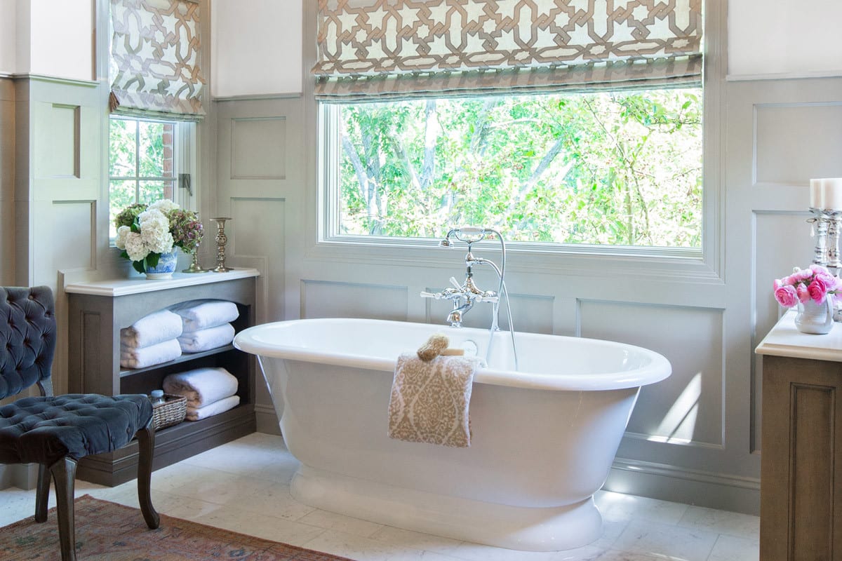 an airy bathroom with a large freestanding tub