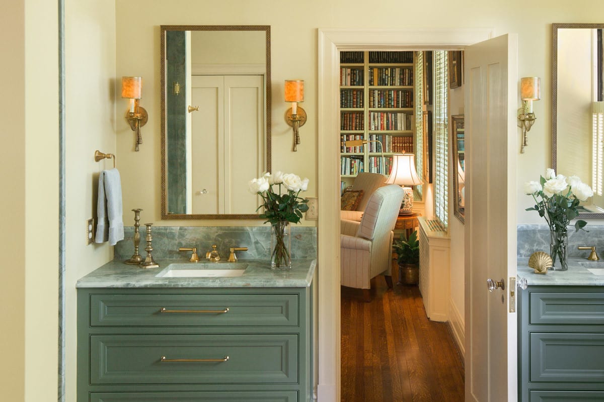 Gorgeous St. Louis bathroom remodel with sage green cabinetry and countertops with gold accents