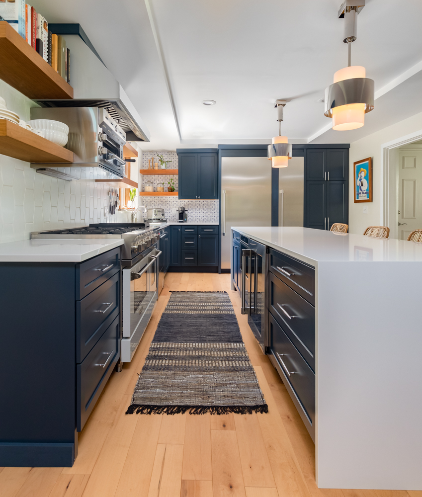 Gorgeous kitchen with navy cabinetry and grey countertops