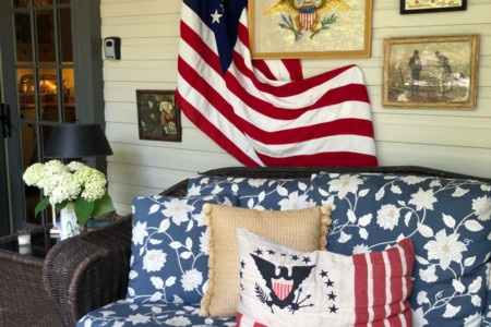 cozy couch on front porch with patriotic decor