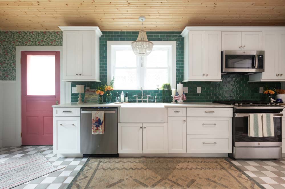 cottage style eclectic kitchen with white cabinetry and bright patterned accents and decor