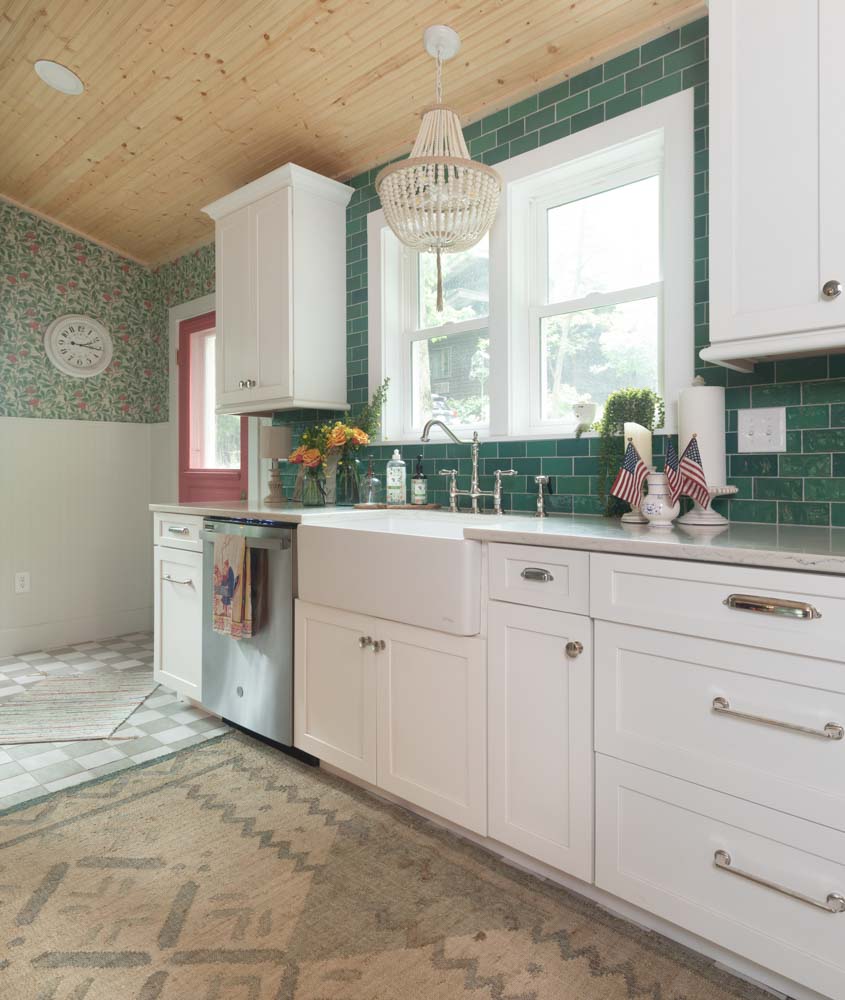 eclectic kitchen with green backsplash against white cabinetry and other natural accents