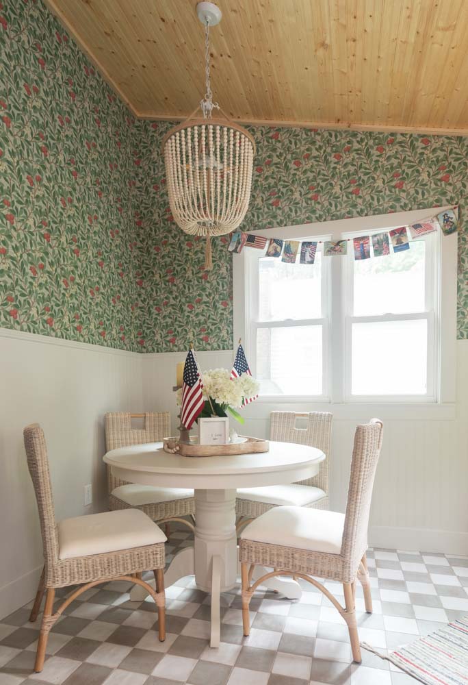cottage style dining room with floral wallpaper and wooden accents