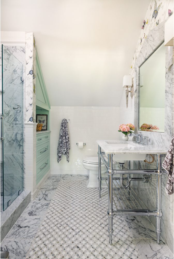 bright white bathroom with a marble tiled shower and floor