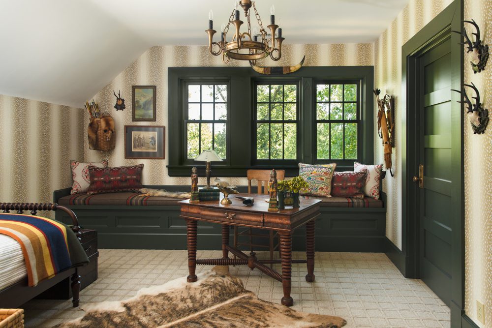 large window seat in bedroom with green trim and natural accents