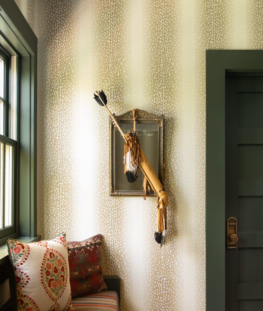 woodsy styled room with animal print wallpaper and natural light peering in