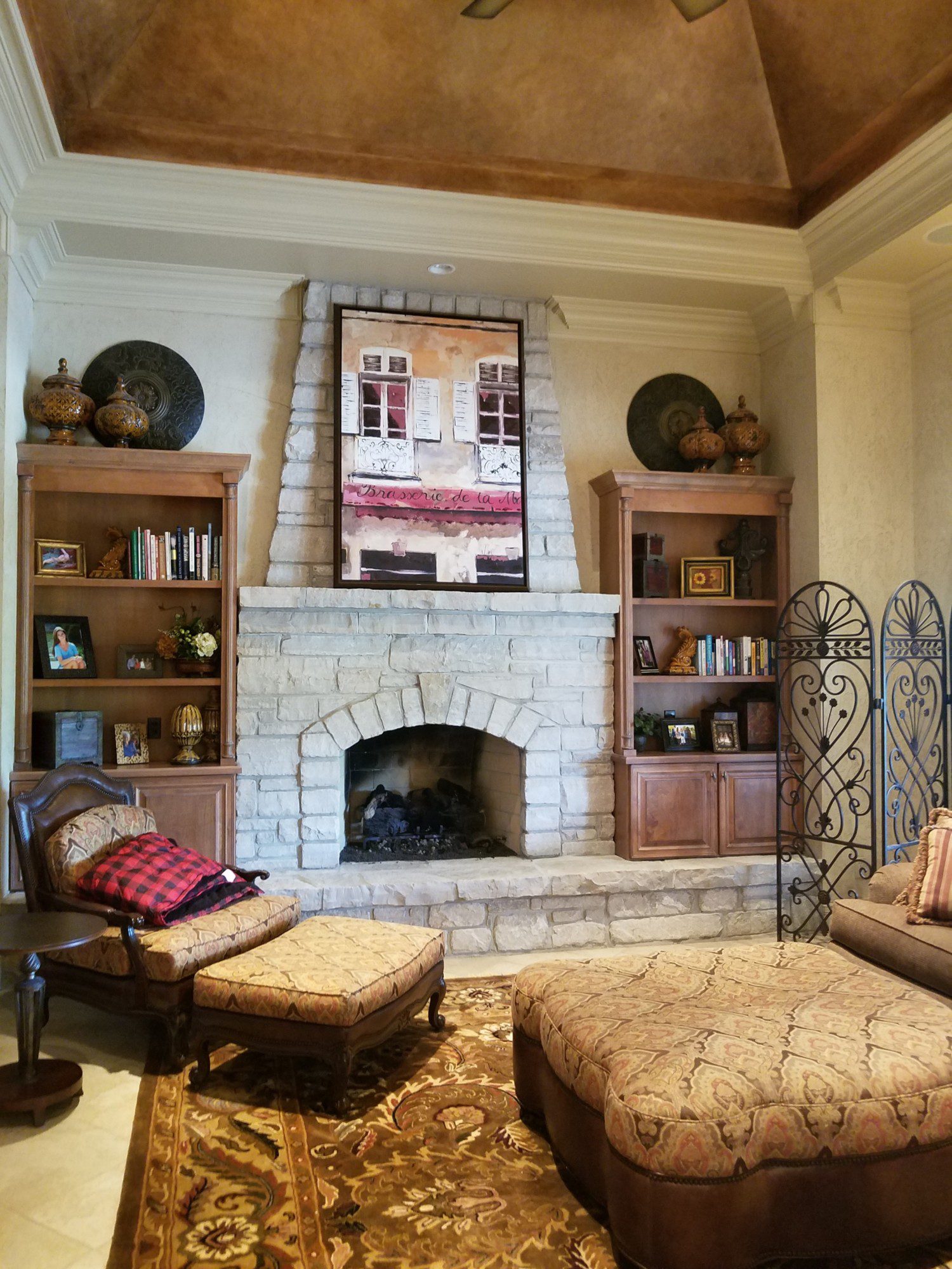 large stone fireplace in living room with tuscan decor