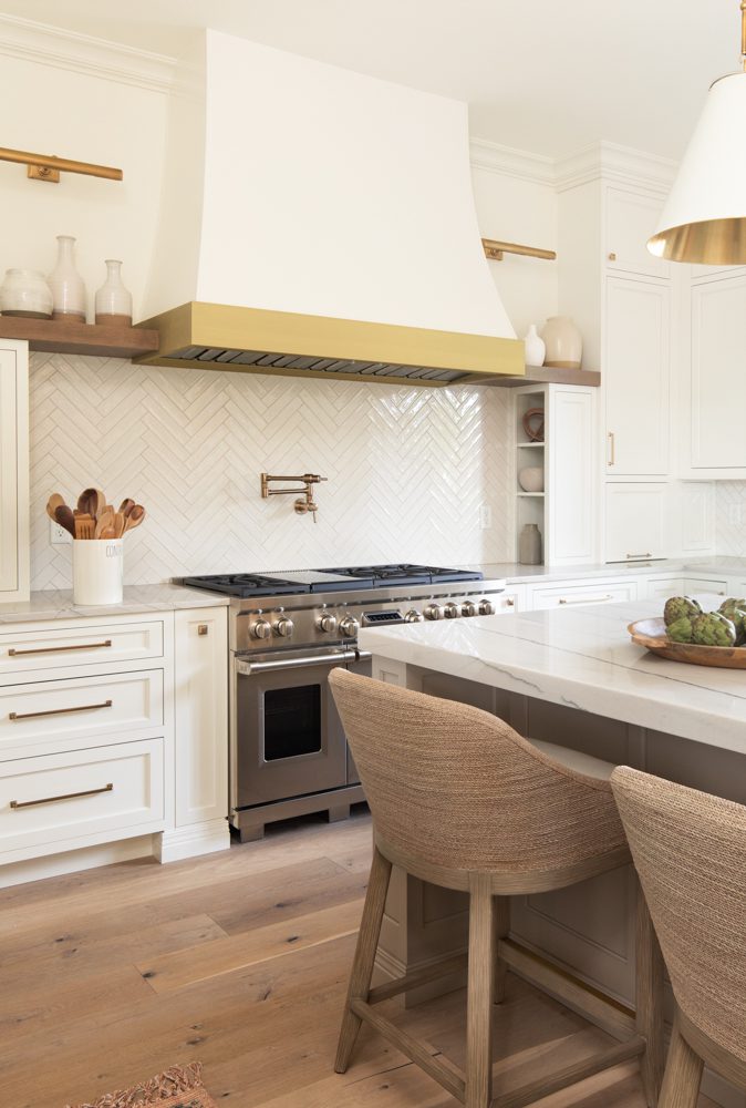 spacious bright kitchen with geometric tile and gold accents
