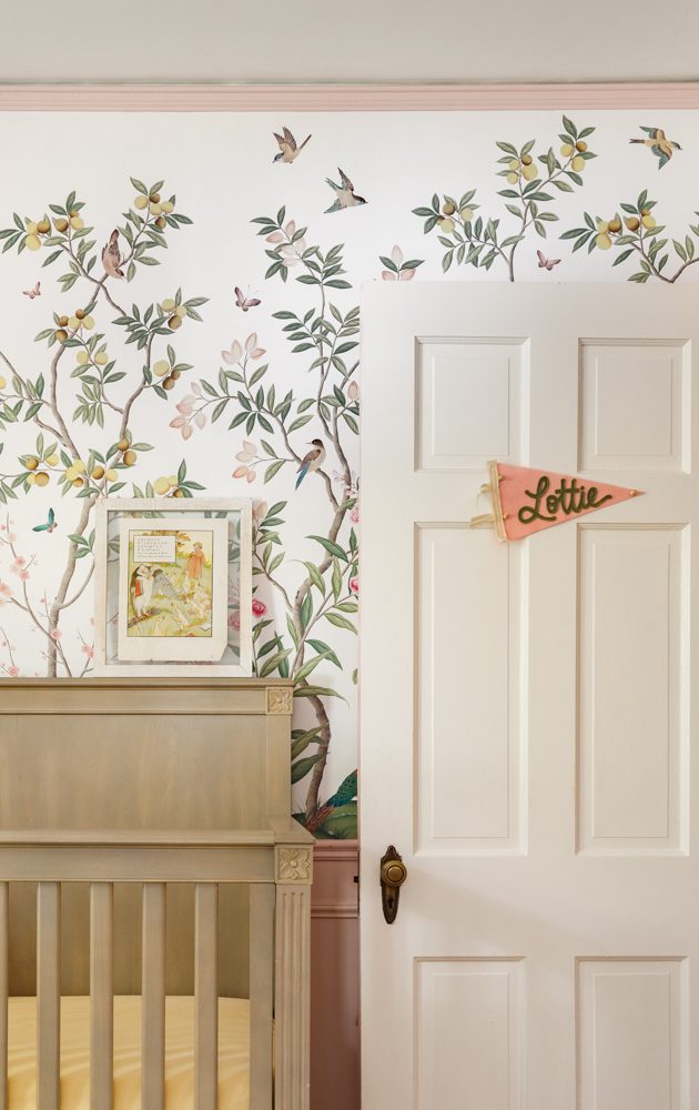 floral nursery with pastel colors and a beige crib