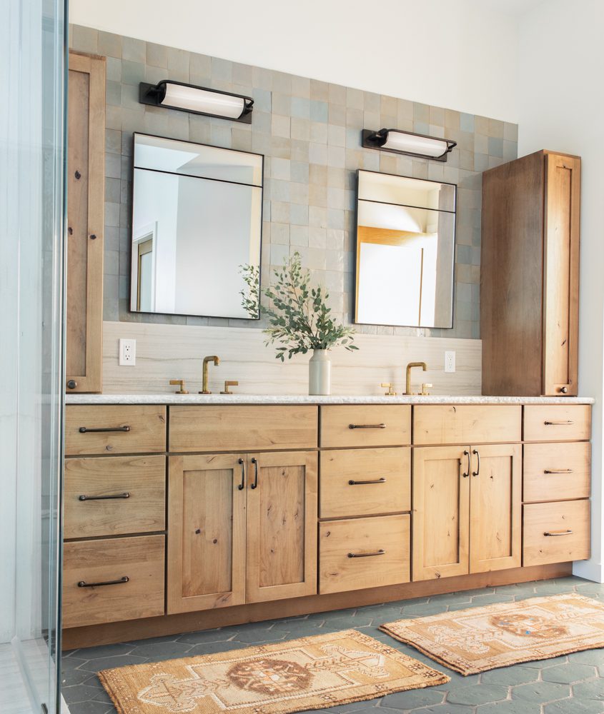 eclectic large double vanity with gold and black hardware and natural accents
