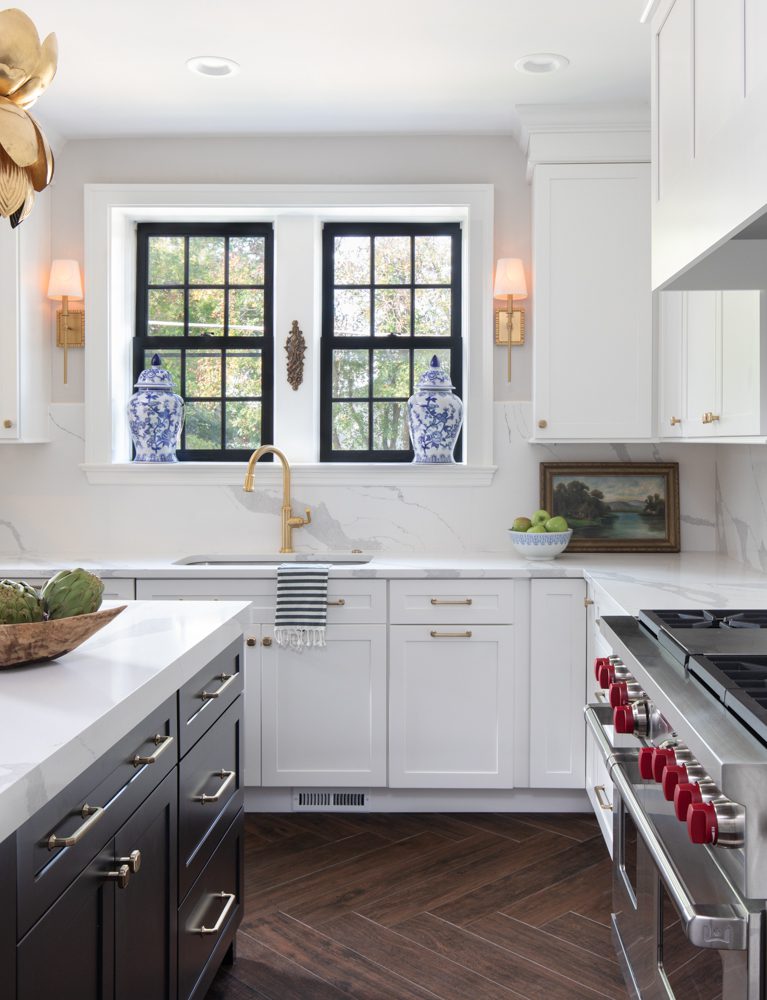 bright kitchen with marble countertops and black and gold accents