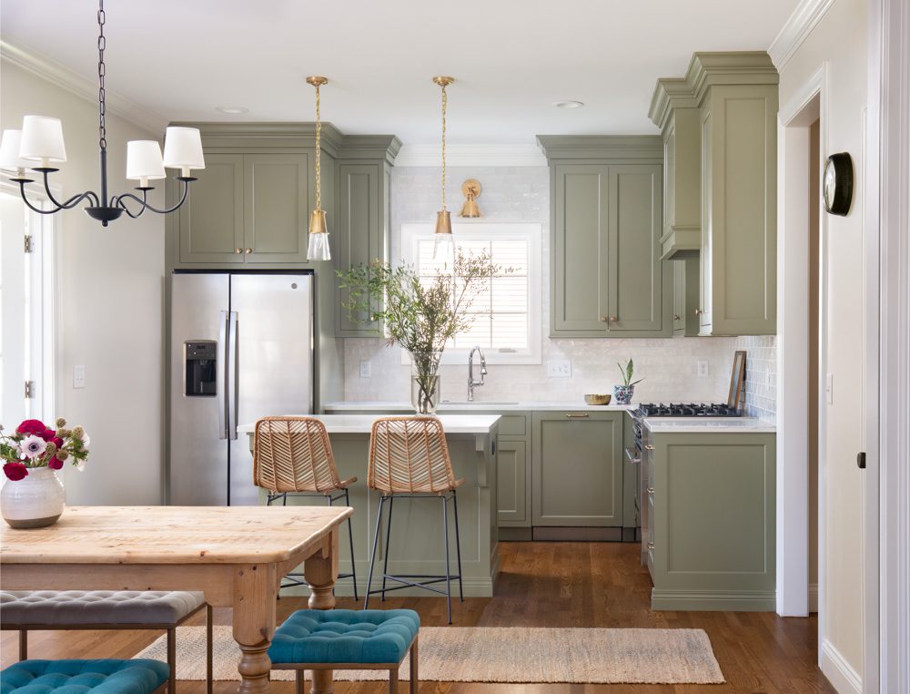 kitchen with sage green cabinetry and gold and natural accents