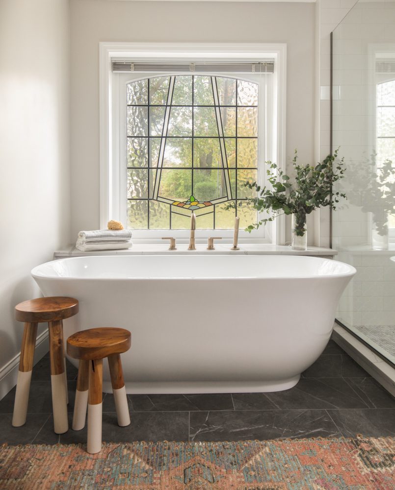 large white freestanding bathtub with natural decor