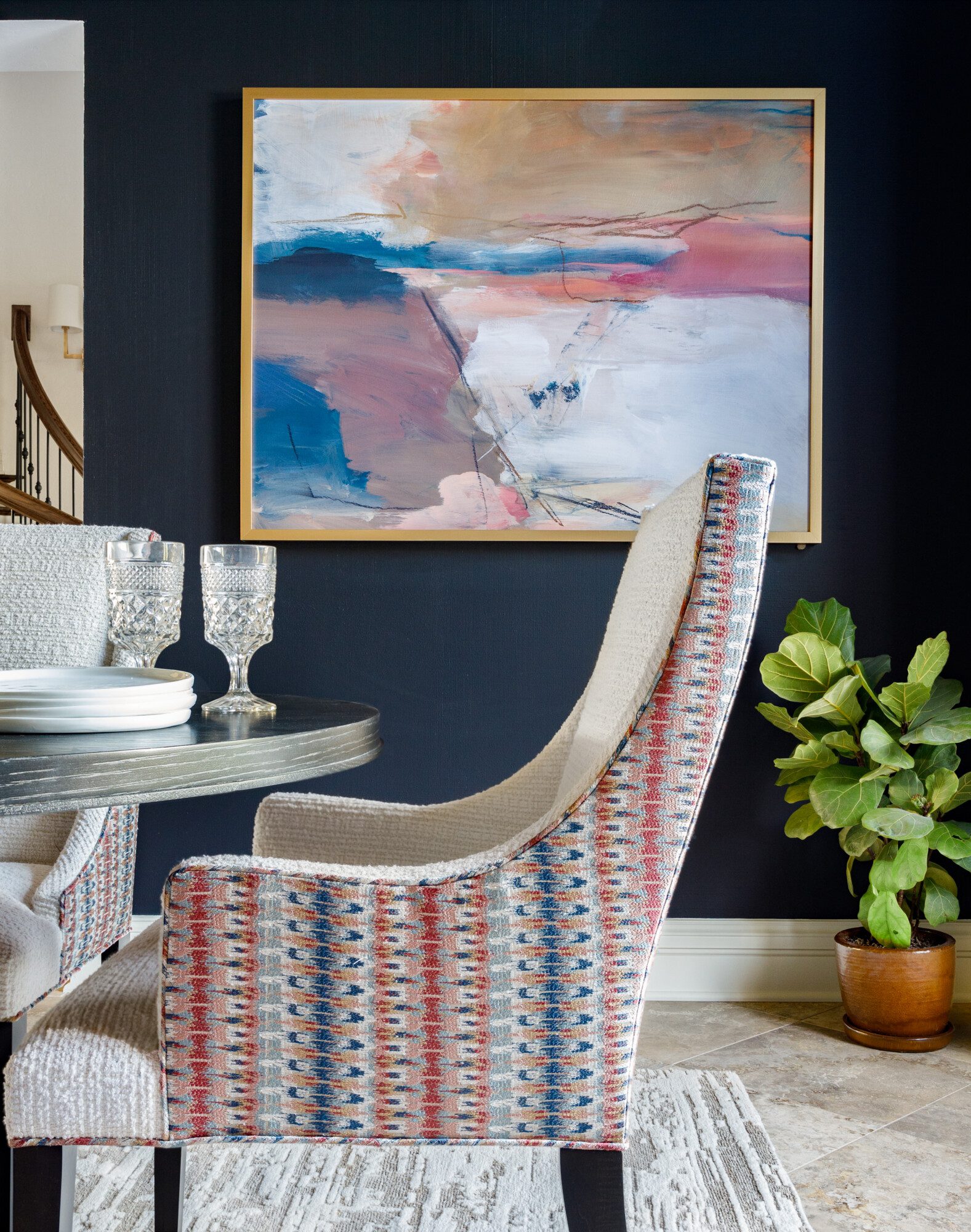 Large painting on navy blue dining room wall