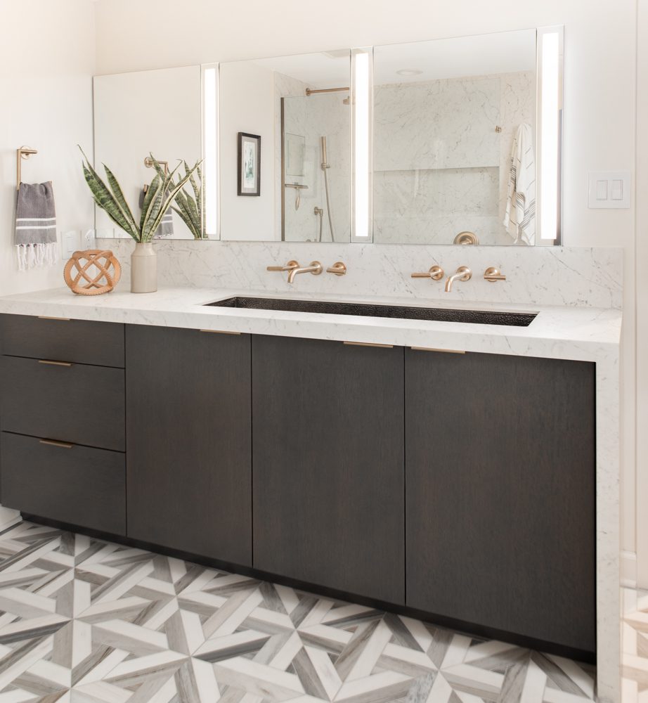 modern double vanity with grey cabinetry and gold hardware