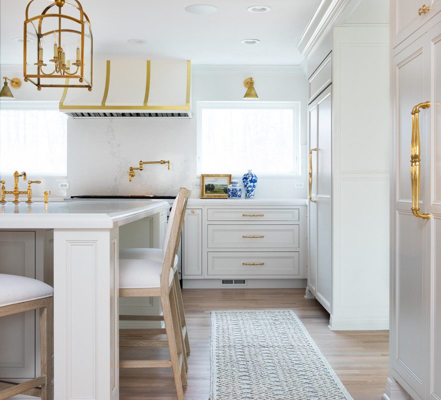 spacious white kitchen with gold accents