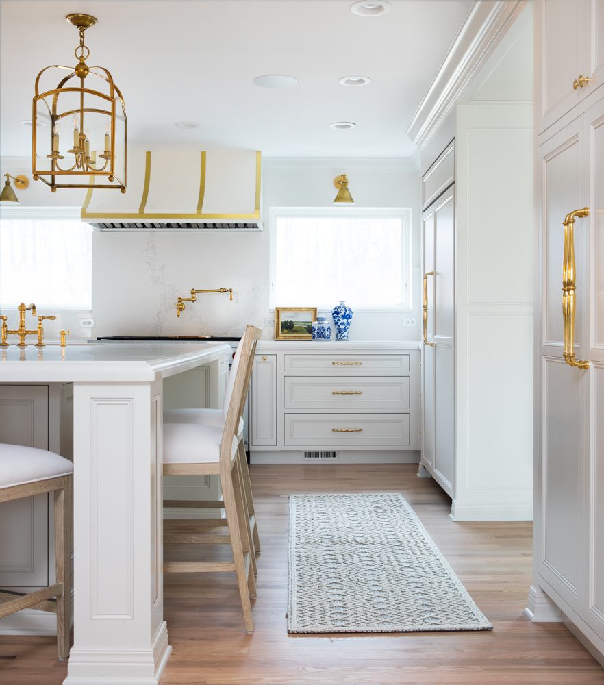 spacious white kitchen with gold accents