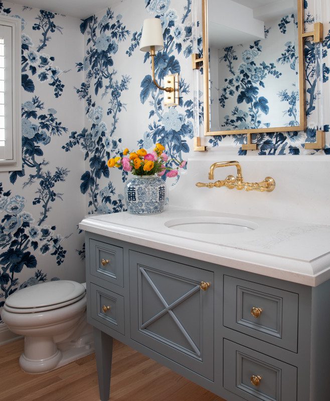 gorgeous bathroom with blue cabinetry and floral wallpaper