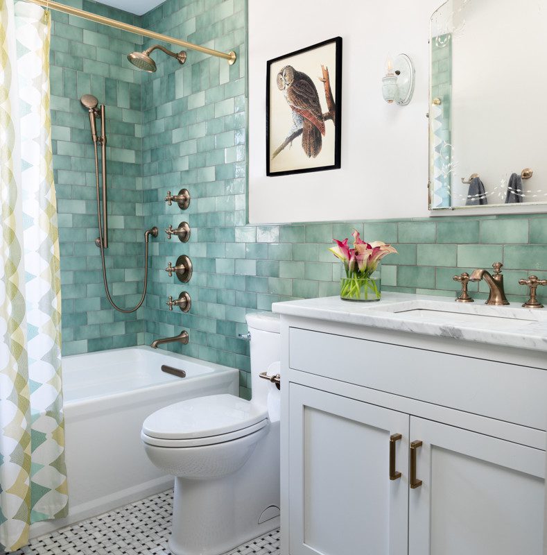 white bathroom with a green tiled shower and walls