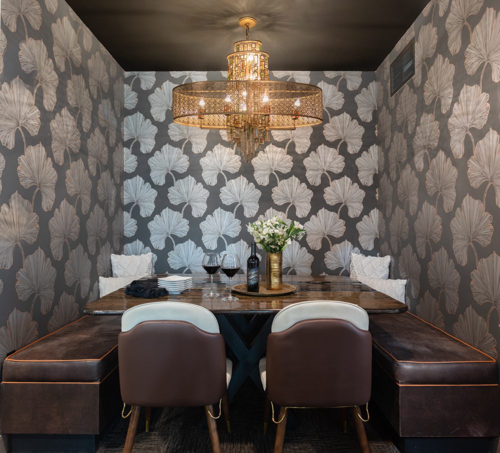 gorgeous dining nook with floral wallpaper and gold accents