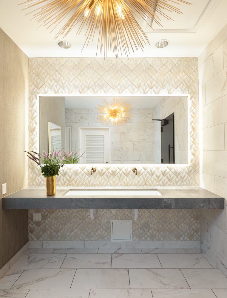bright and airy double vanity with cream colored geometric tile