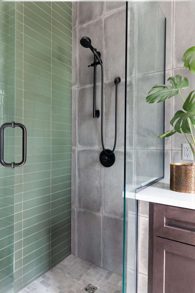 walk in shower with green and grey tile