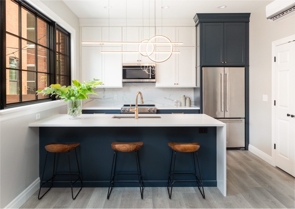 modern kitchen with white countertops and blue cabinetry