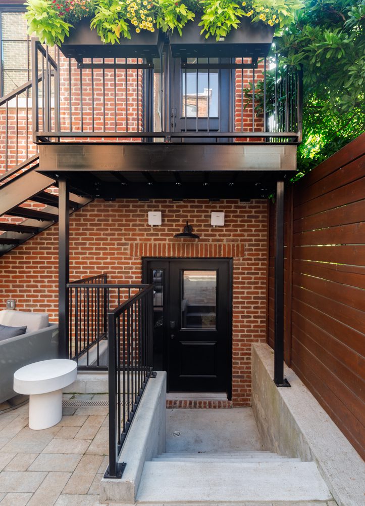 entry way to apartment with black accents and brick exterior