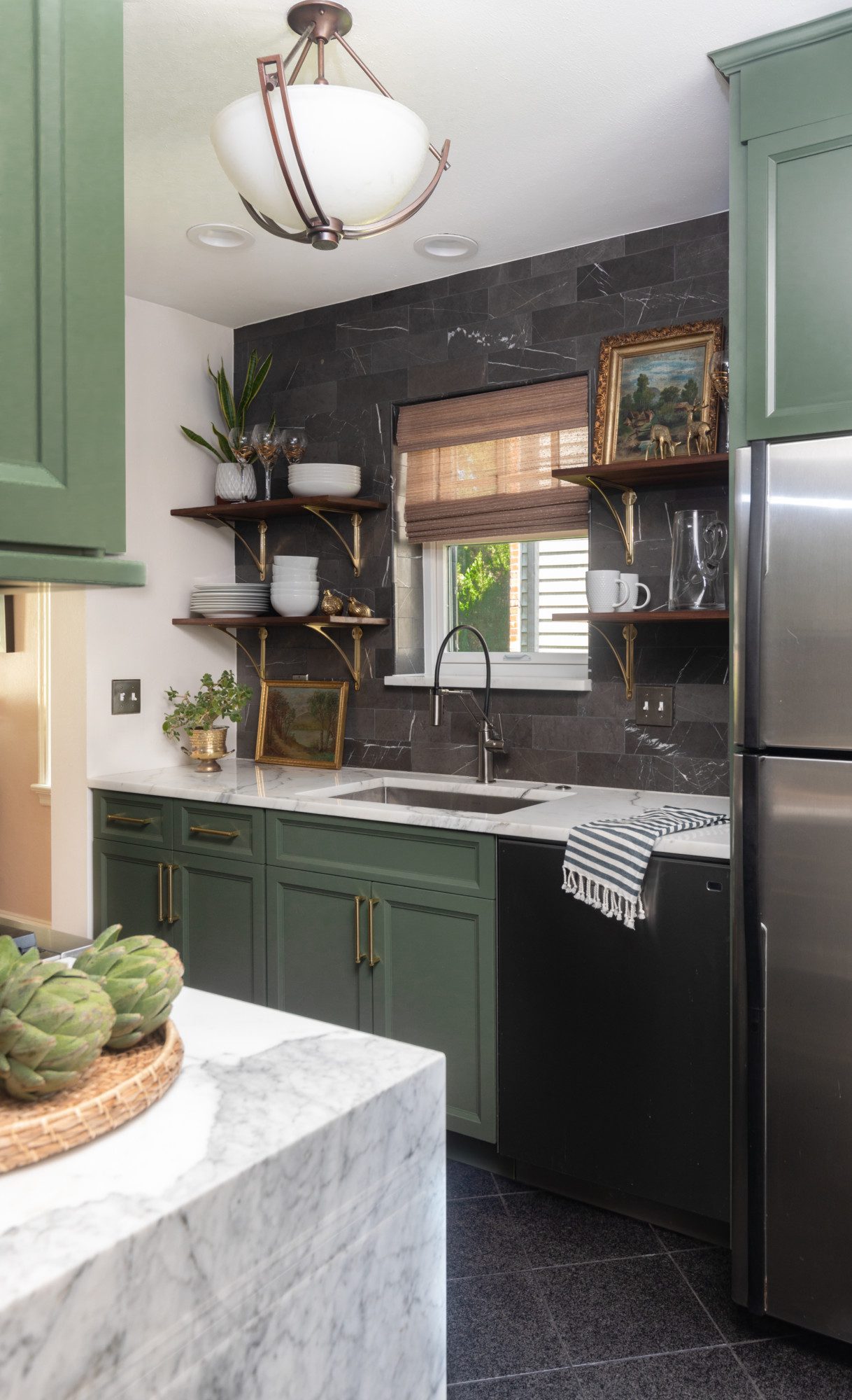 small kitchen with natural accents and green cabinetry