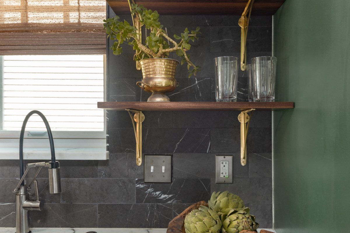 kitchen with gold decor and grey tiled backsplash