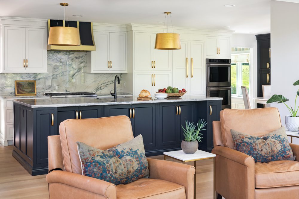 a large kitchen with a blue island and gold accents