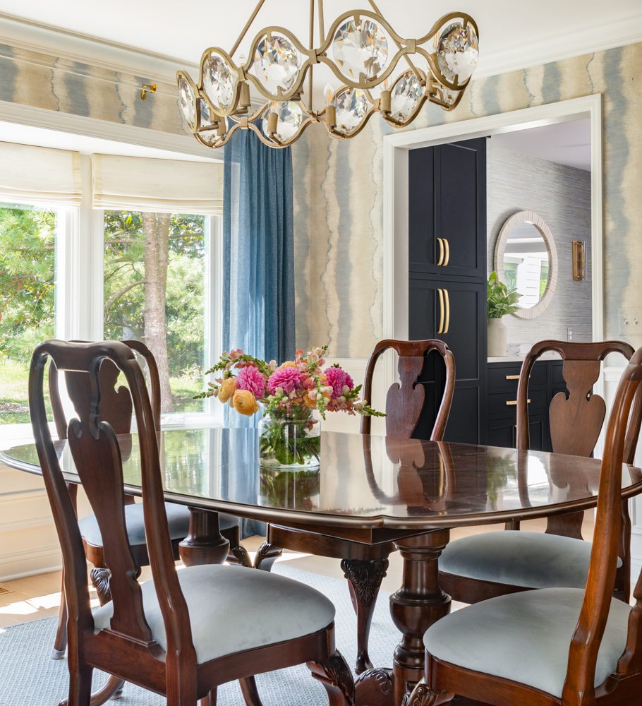 a dark brown dining table in a room with gold accents