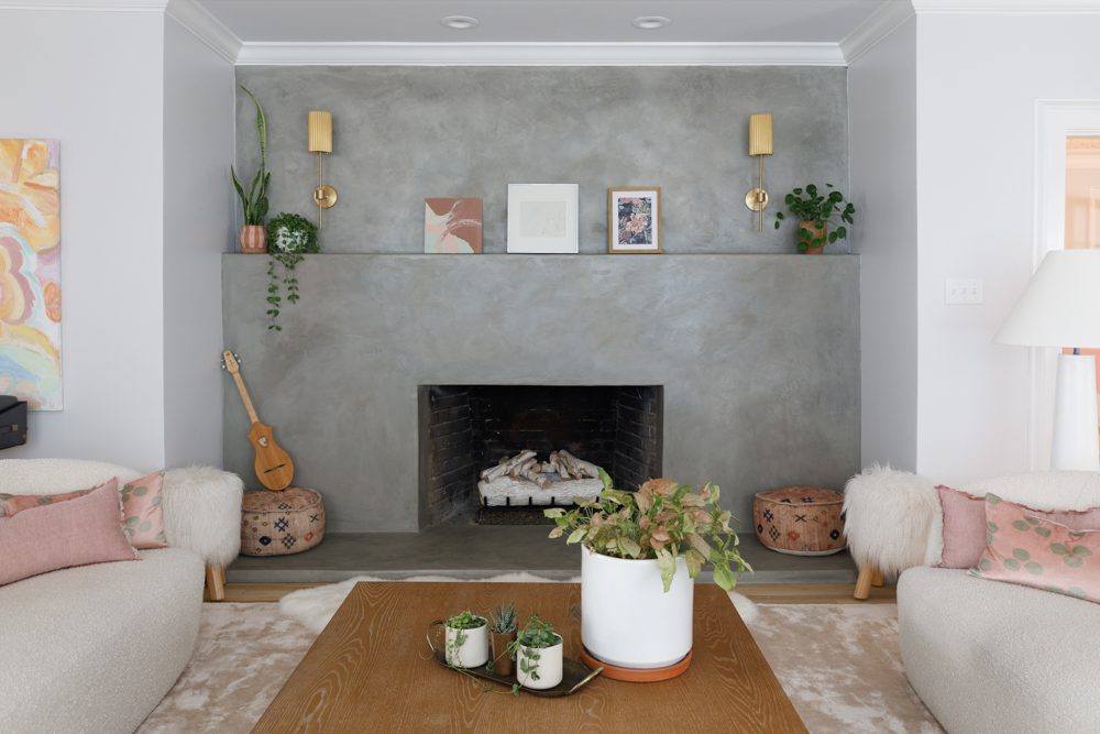 a large cement fireplace in a bohemian living room