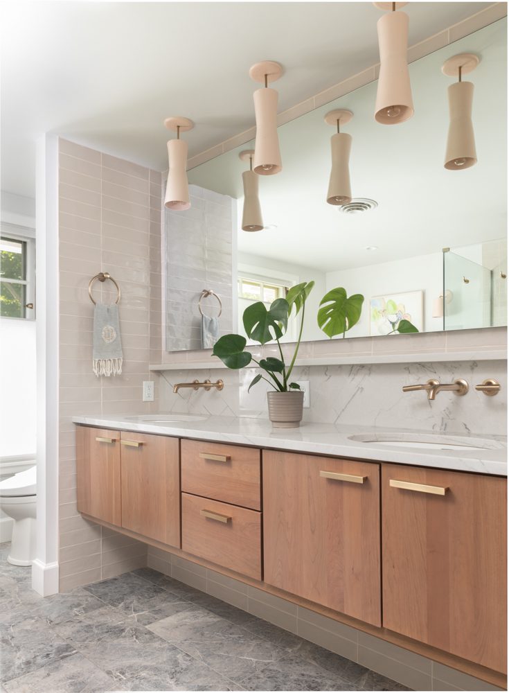 a spacious bathroom with wooden cabinetry and natural accents