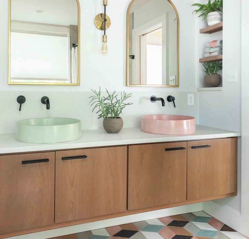 a double vanity with geometric accents and pastel sinks