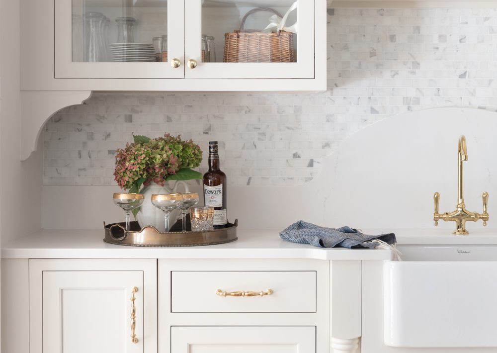 a large white farm sink in a bright kitchen