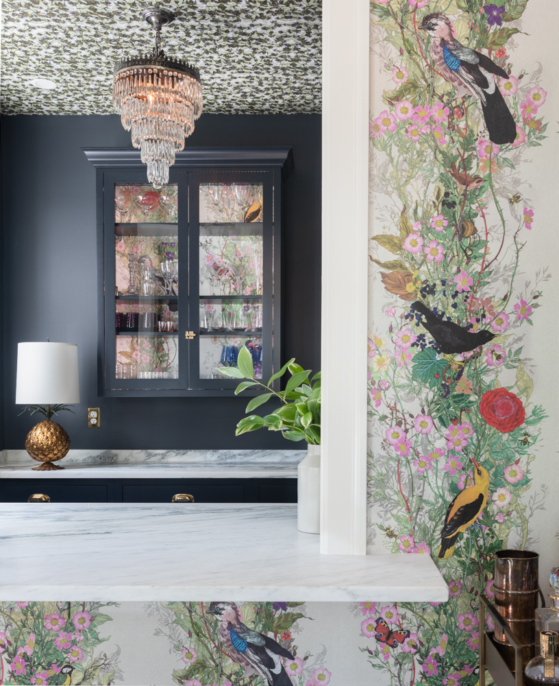a wet bar with floral wallpaper