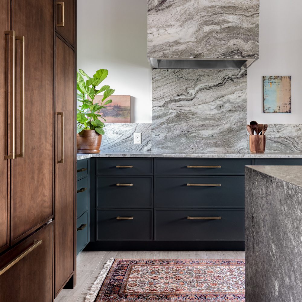 modern kitchen with marble slab backsplash and wood elements