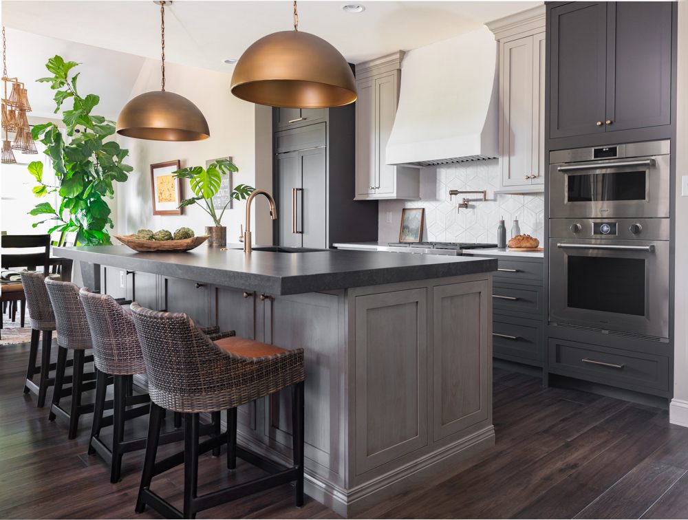 a spacious kitchen with grey accents and elements