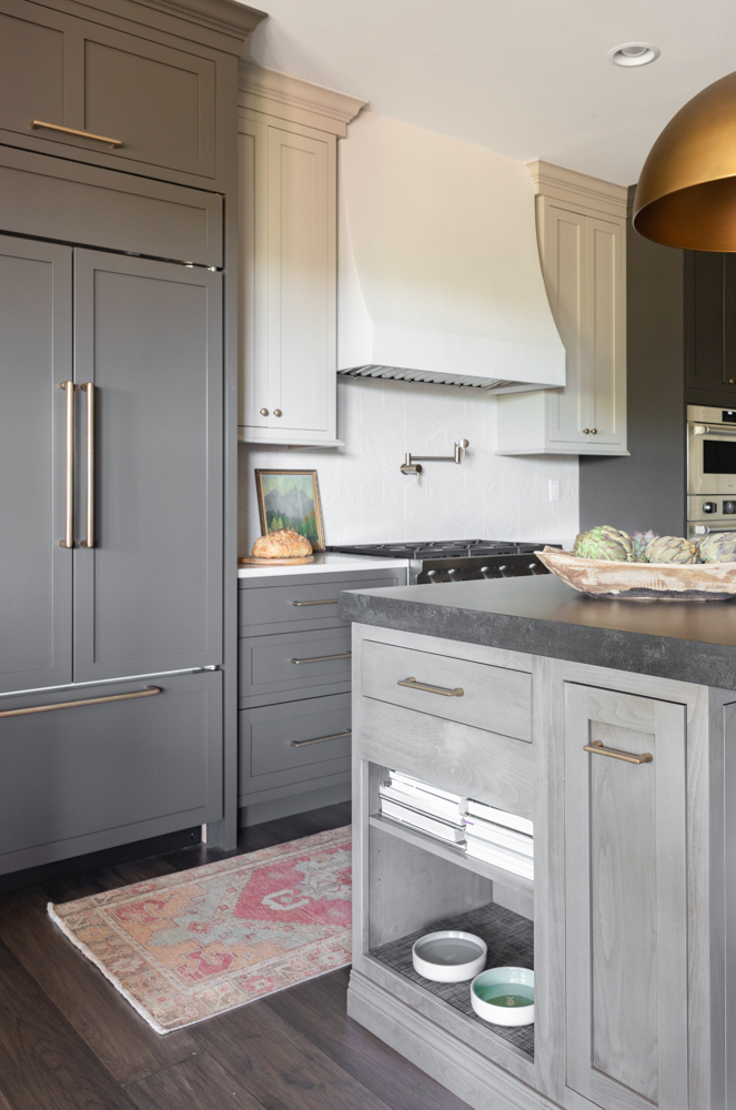 a kitchen with grey cabinetry and an island