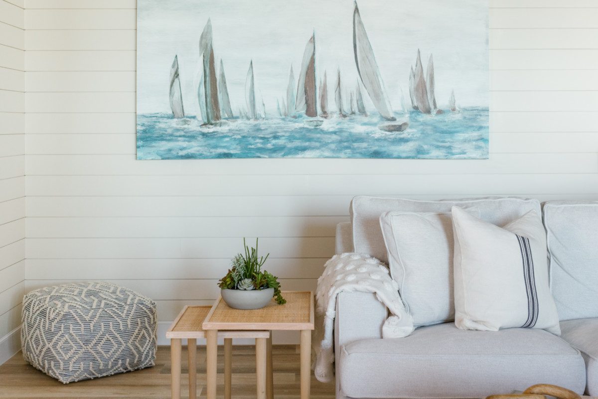 a coastal painting on a wooden accent wall